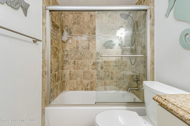 full bathroom featuring bath / shower combo with glass door, toilet, and vanity