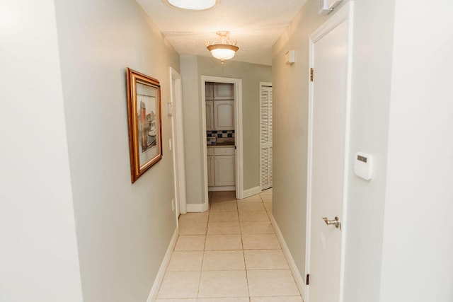 corridor featuring light tile floors