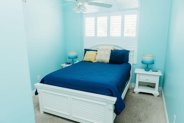 bedroom featuring ceiling fan and light carpet