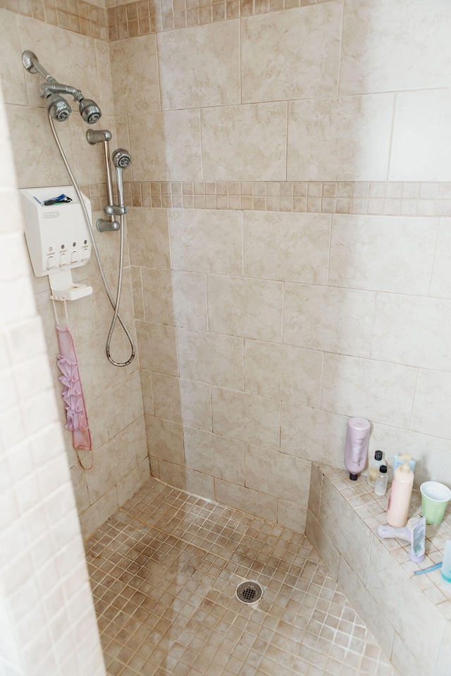 bathroom with tiled shower