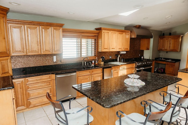 kitchen featuring range with two ovens, a center island, dishwasher, wall chimney range hood, and a kitchen breakfast bar