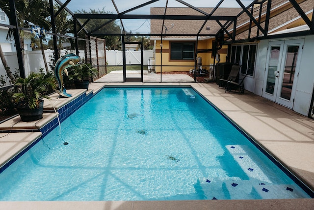 view of pool with french doors, a patio area, and a lanai