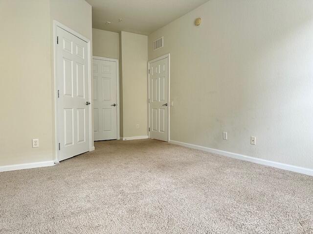 unfurnished bedroom with light carpet