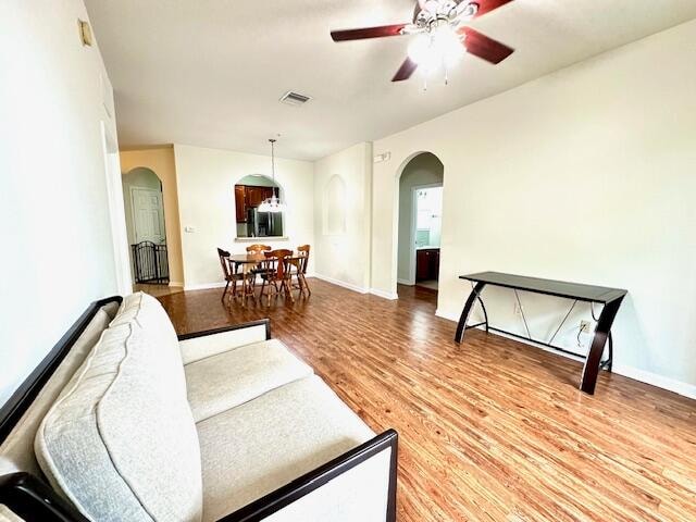 living room featuring ceiling fan and light wood-type flooring