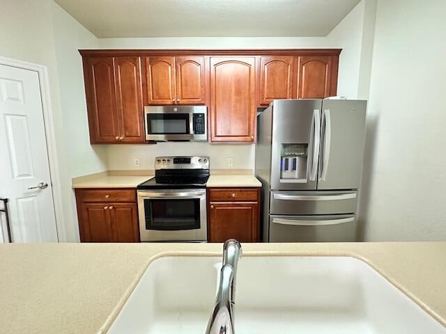 kitchen with sink and appliances with stainless steel finishes