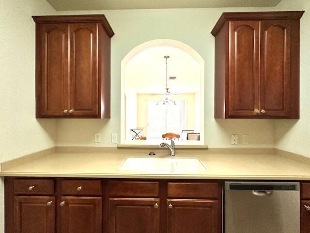 kitchen featuring dishwasher, sink, and hanging light fixtures