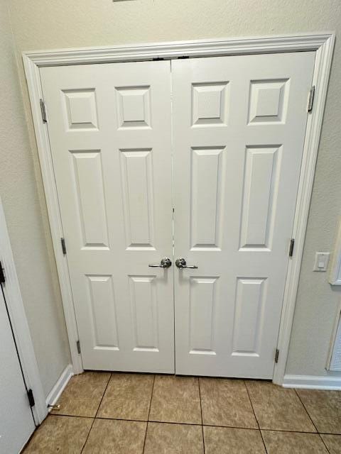 interior details featuring light tile floors