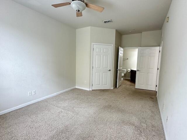 unfurnished bedroom with ceiling fan and light carpet