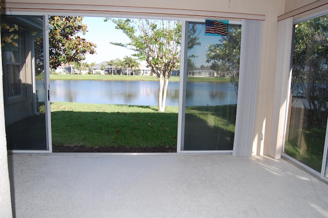 unfurnished sunroom with a water view