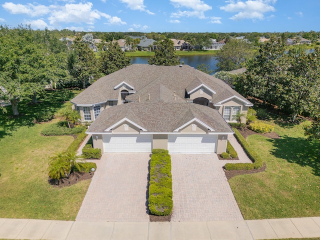 view of front facade with a front yard and a garage