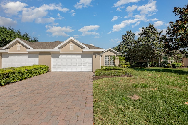 single story home with a front yard and a garage