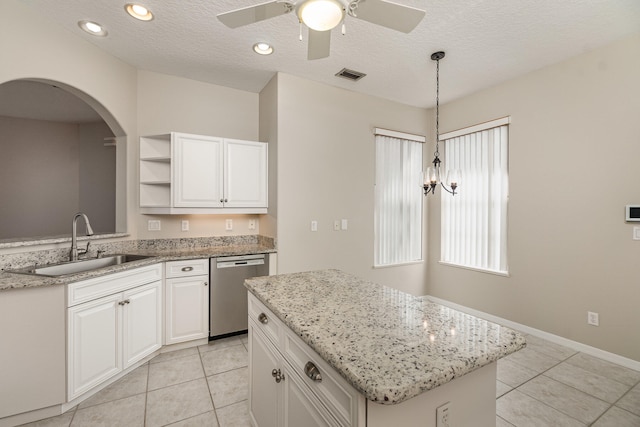 kitchen featuring ceiling fan, white cabinets, sink, dishwasher, and light tile flooring