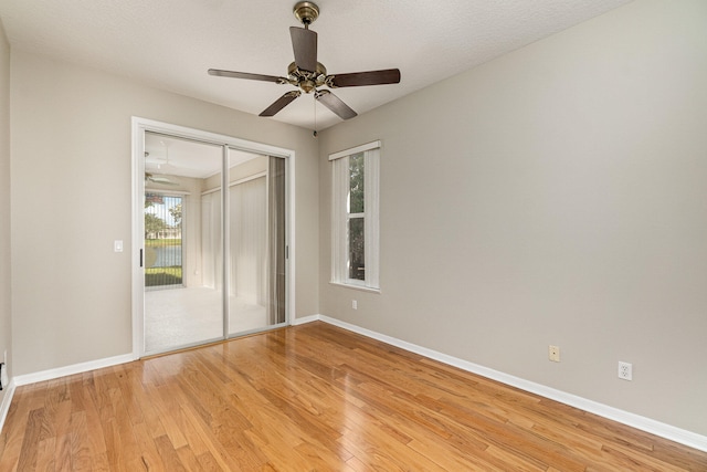 spare room featuring light hardwood / wood-style flooring and ceiling fan