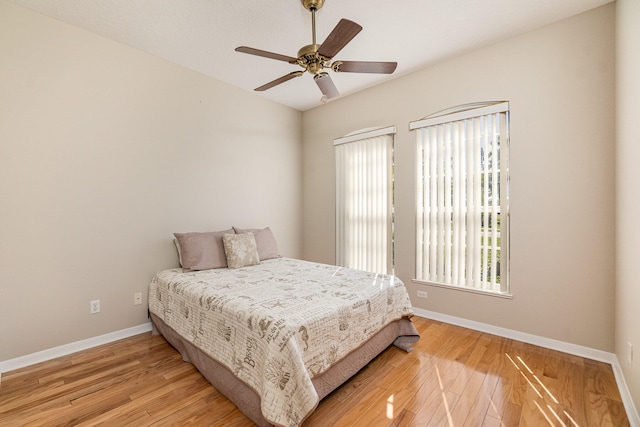 bedroom with light hardwood / wood-style flooring and ceiling fan