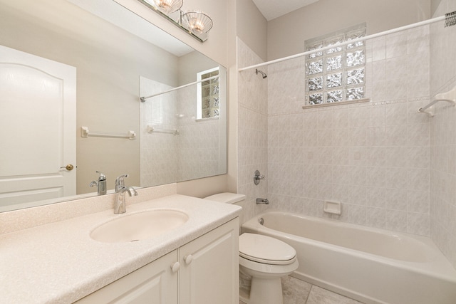 full bathroom featuring tiled shower / bath combo, vanity, toilet, and tile flooring