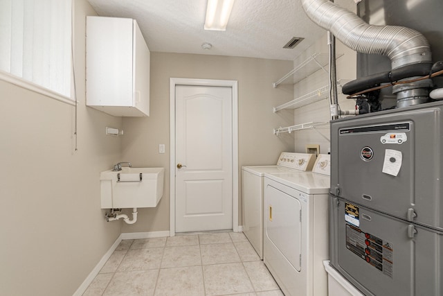 washroom featuring hookup for a washing machine, cabinets, separate washer and dryer, sink, and light tile floors