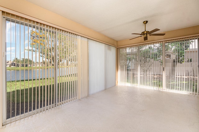 unfurnished sunroom with ceiling fan and a healthy amount of sunlight