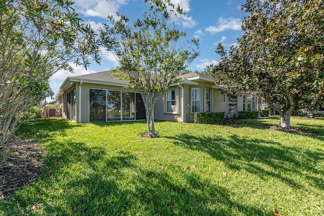 rear view of house with a lawn