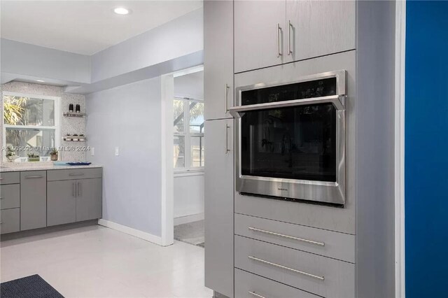 kitchen featuring gray cabinetry and oven