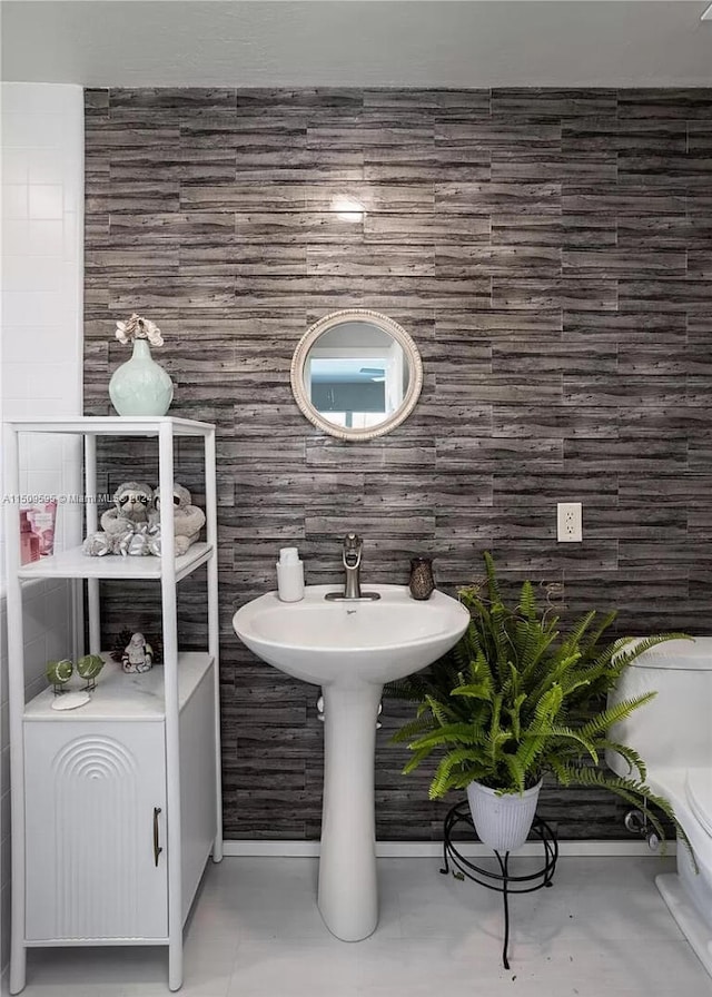 bathroom featuring tile walls and tile flooring