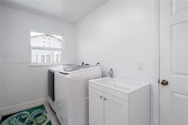 laundry area with hookup for an electric dryer, cabinets, and washer and clothes dryer