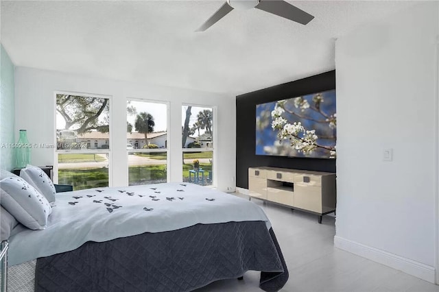 bedroom with ceiling fan and multiple windows