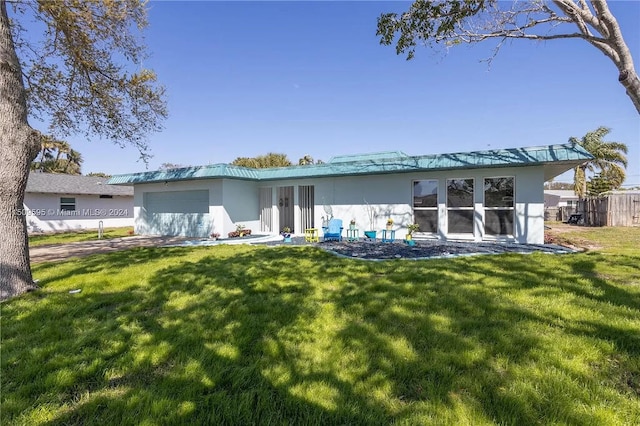 back of house featuring a lawn