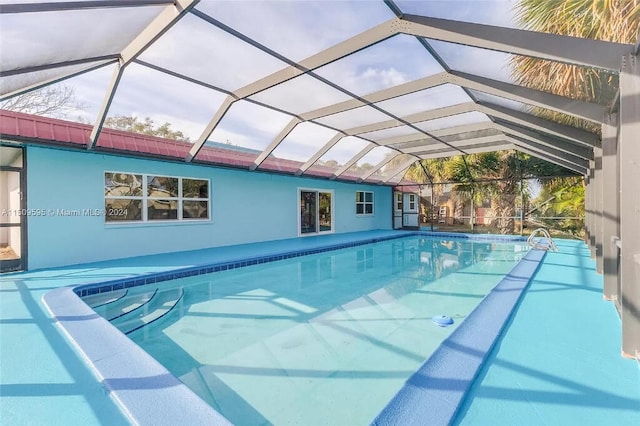 view of pool with glass enclosure