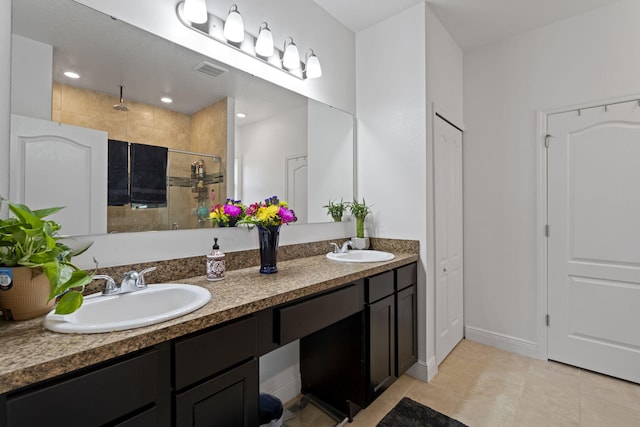 bathroom featuring tile patterned flooring, vanity, and a shower with shower door