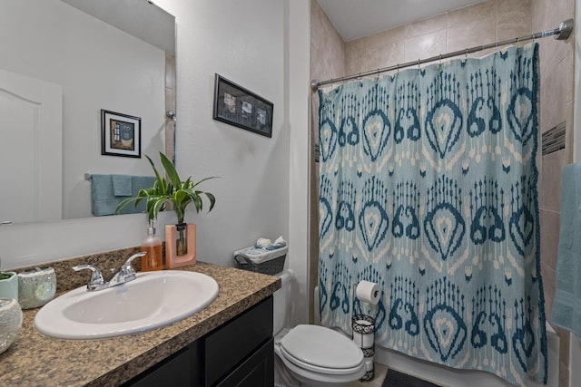 bathroom with vanity, toilet, and walk in shower