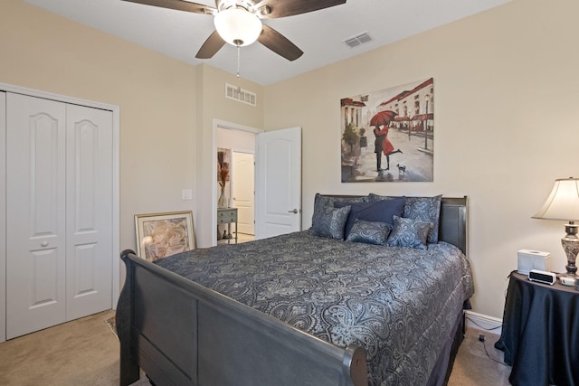 bedroom featuring ceiling fan, a closet, and light colored carpet