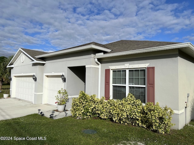 exterior space featuring a garage and a yard