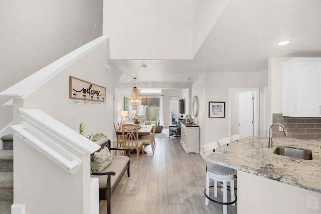 living room featuring sink and light wood-type flooring