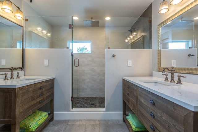 bathroom featuring walk in shower, a wealth of natural light, dual bowl vanity, and tile flooring