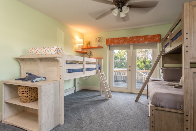 unfurnished bedroom featuring ceiling fan, dark carpet, and access to exterior