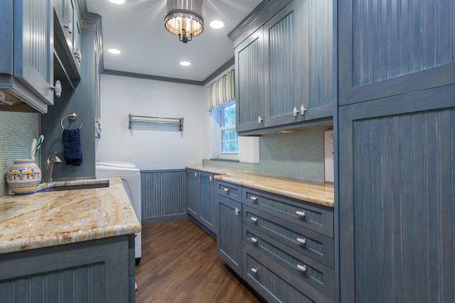 kitchen featuring light stone counters, sink, tasteful backsplash, dark hardwood / wood-style floors, and ornamental molding