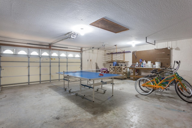 garage with a garage door opener and a workshop area