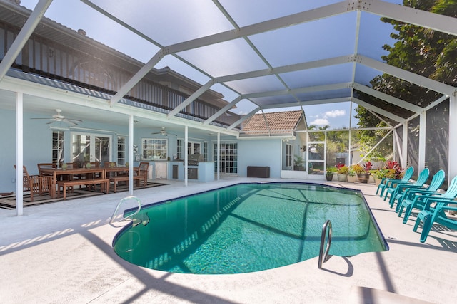 view of swimming pool with a patio area, french doors, ceiling fan, and a lanai