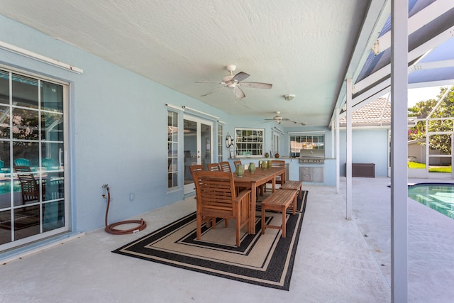 view of patio featuring ceiling fan, a grill, and a lanai