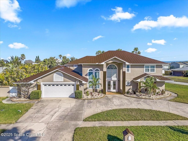 view of front of property with a garage and a front yard