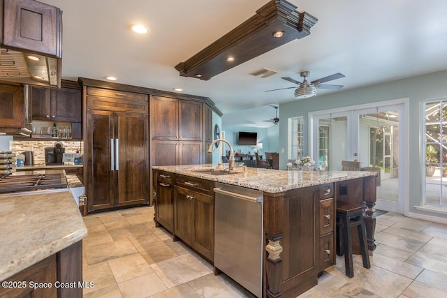 kitchen with recessed lighting, visible vents, a kitchen island with sink, a sink, and dishwasher