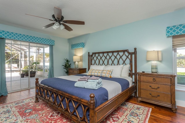 bedroom featuring access to outside, wood finished floors, and a ceiling fan