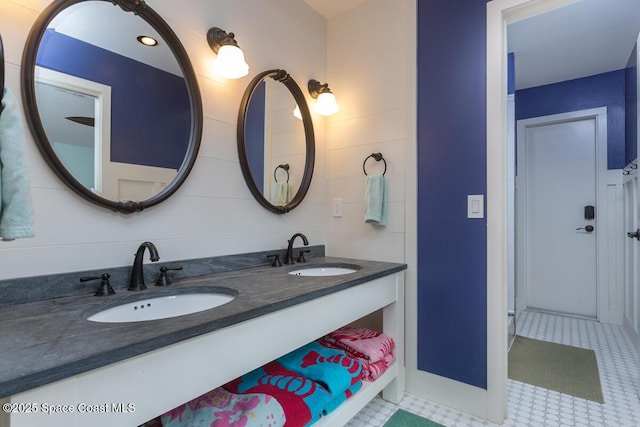 bathroom with double vanity, tile patterned flooring, and a sink