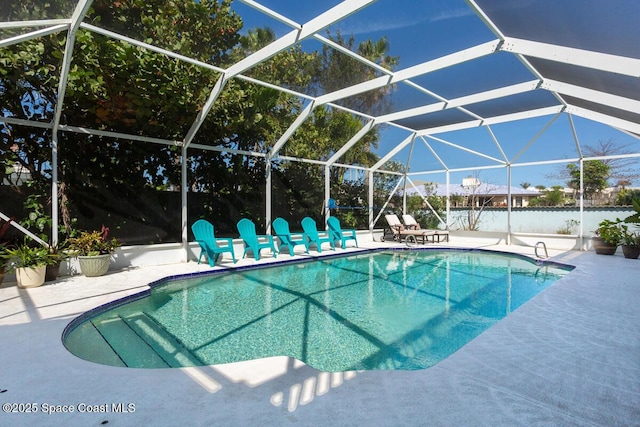 outdoor pool with a patio, a lanai, and fence