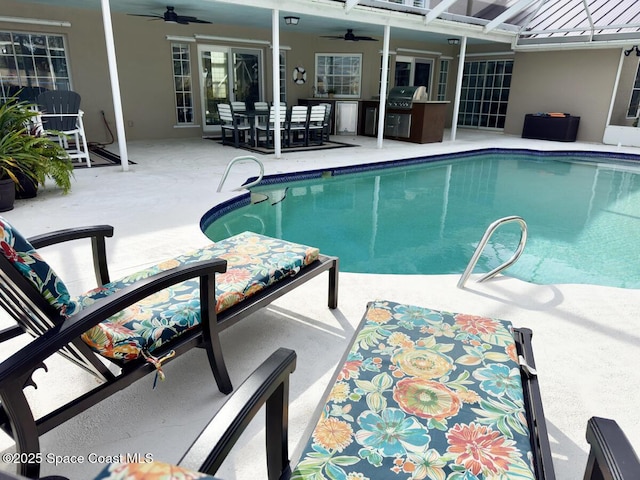 pool featuring a grill, an outdoor kitchen, a ceiling fan, and a patio