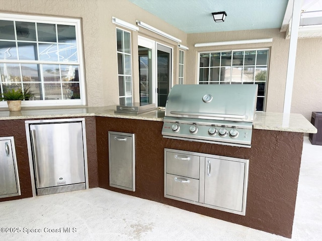 view of patio with area for grilling and grilling area