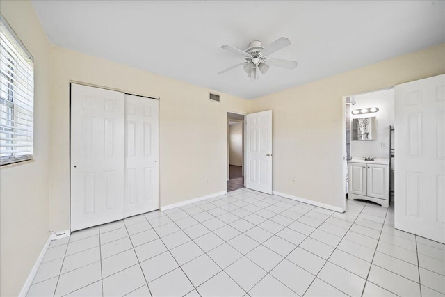 unfurnished bedroom with multiple windows, a closet, ceiling fan, and light tile floors