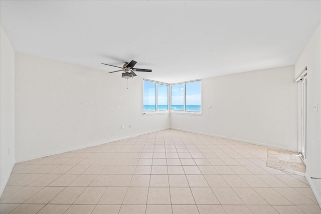 empty room featuring ceiling fan and light tile floors