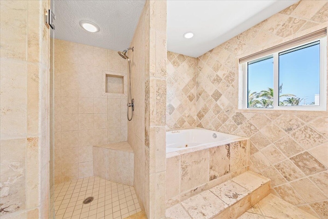 bathroom with tile walls, a textured ceiling, and shower with separate bathtub