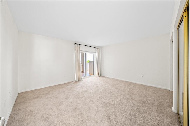 spare room with light colored carpet